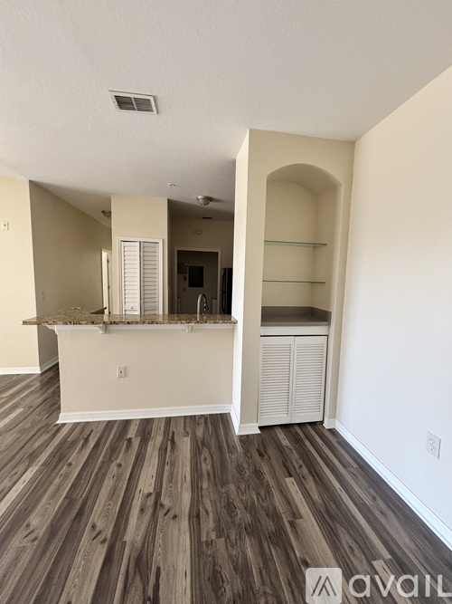 A room with wooden floors and white walls.