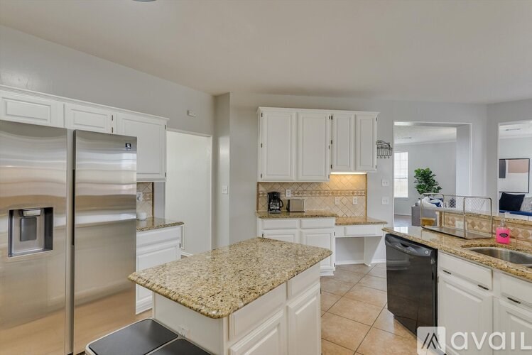 A kitchen with granite countertops and stainless steel appliances.
