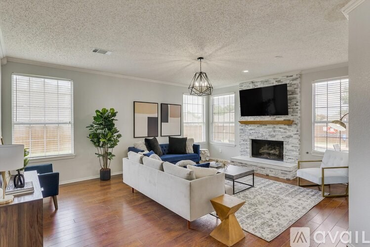 A living room with a fireplace and a television.