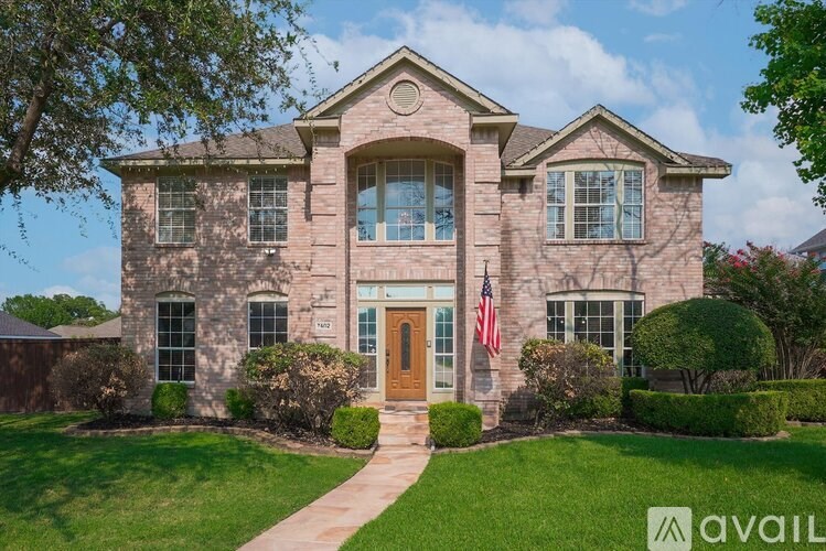 A house with a brown door and a flag on it.