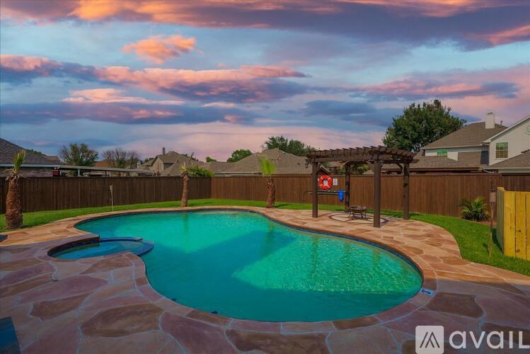 A residential area with a pool and a fence.