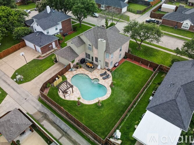 A backyard with a pool and a patio area.