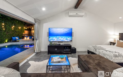 A living room with a television and a pool.