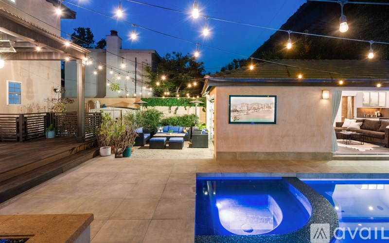 A pool with a lit up blue light in the middle of it.