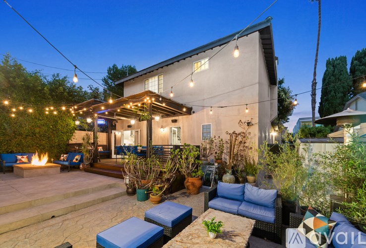 A house with a patio and outdoor furniture is shown.