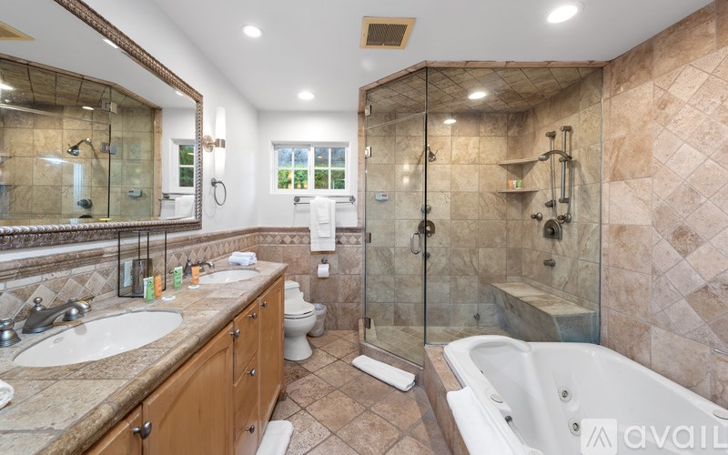 A bathroom with a tub, sink, and toilet.
