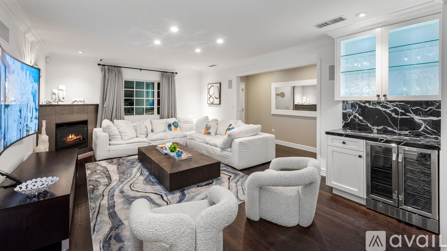 A modern living room with a fireplace and a large couch.
