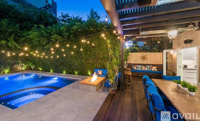 A poolside area with a wooden deck and a bar area.