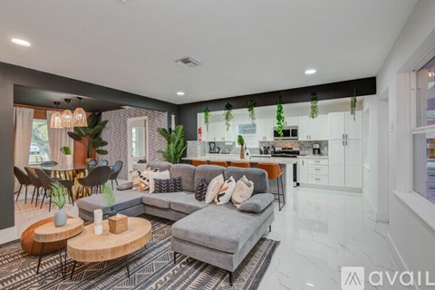 A modern living room with a grey sofa and a coffee table.