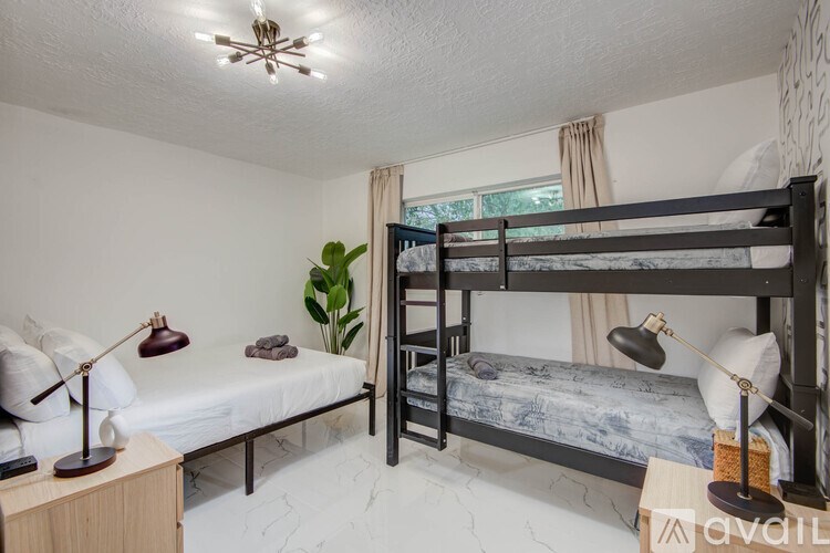 A bedroom with a bunk bed and a single bed.