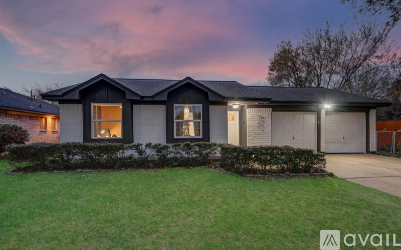 A house with a large front yard is available for purchase.