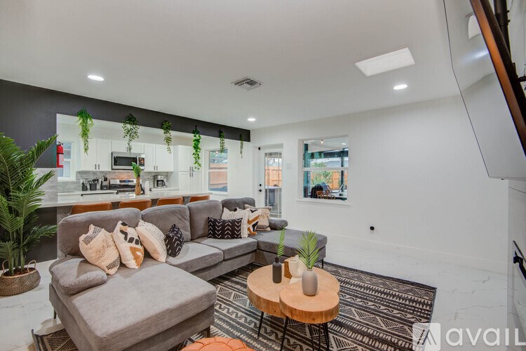 A living room with a grey couch and a wooden coffee table.