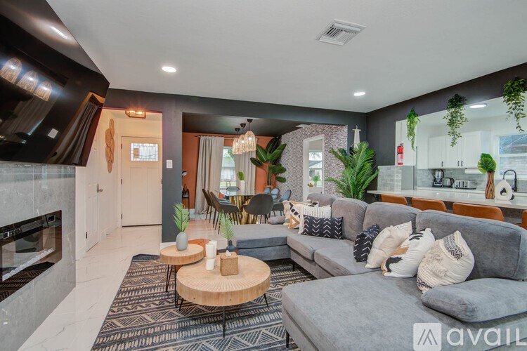 A modern living room with a grey sofa and a wooden coffee table.