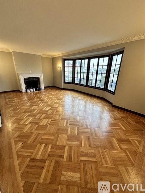 A room with a fireplace and a large window.