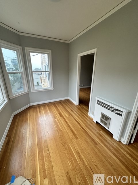 A room with wooden floors and a fireplace.