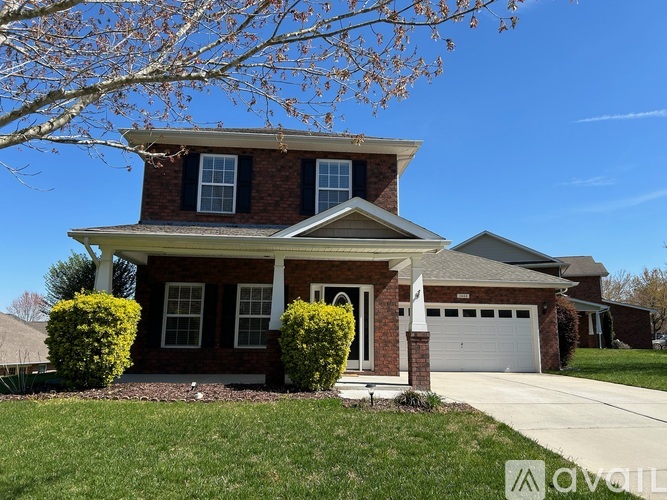 A house with a brick facade and a white garage door.