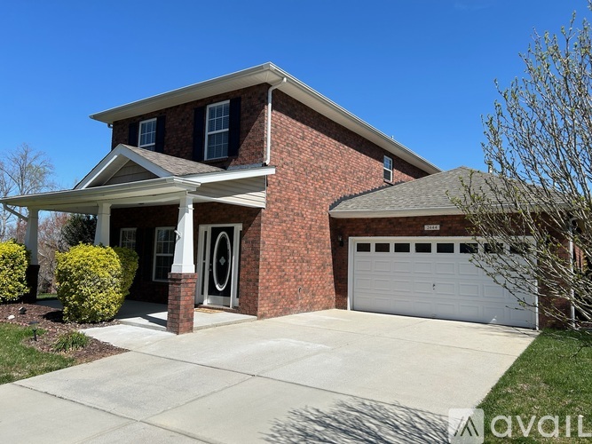 A house with a brick facade and a white garage door.