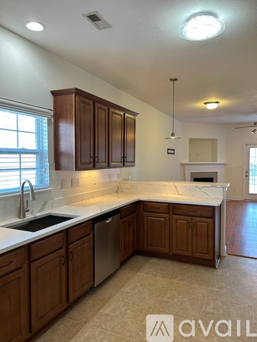 A kitchen with wooden cabinets and a white countertop.