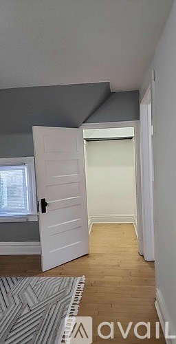 A room with wooden flooring and a white wall.