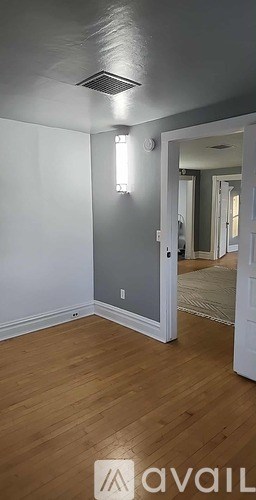 A room with wooden floors and a white door.