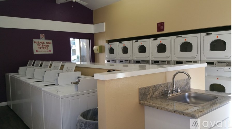 A laundromat with a sign that says "Please use filters.".