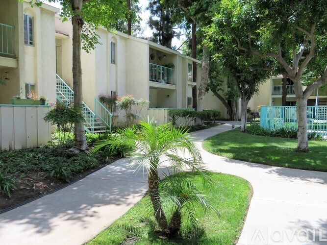 A tree in a courtyard of apartment buildings.