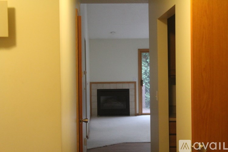 A room with a fireplace and a door leading to a balcony.