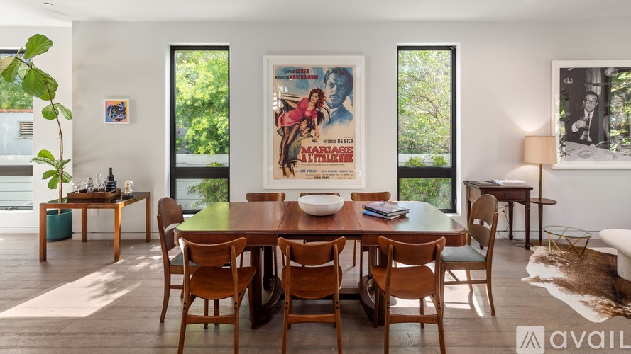 A dining room with a wooden table and chairs.