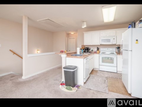 A kitchen with white appliances and a white refrigerator.