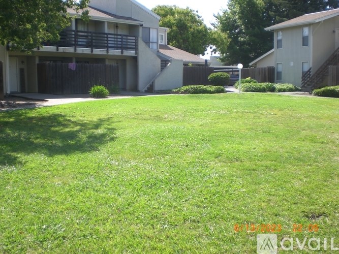 A grassy area in front of apartment buildings.