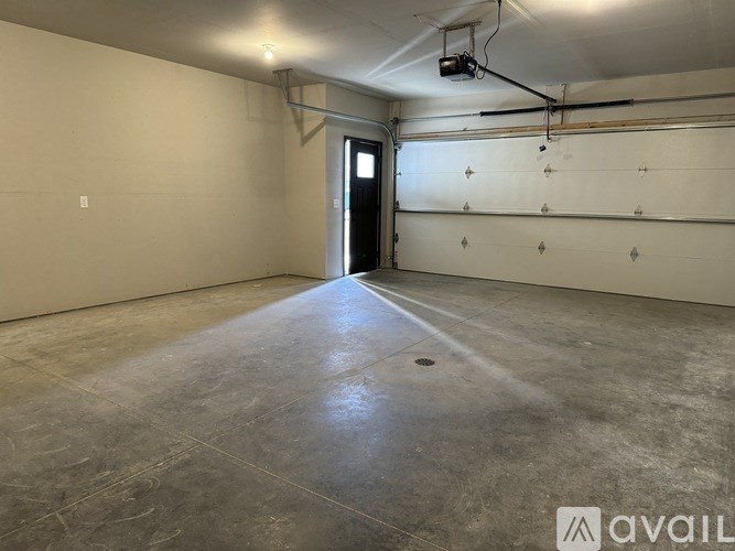 A spacious empty room with a door and a window.
