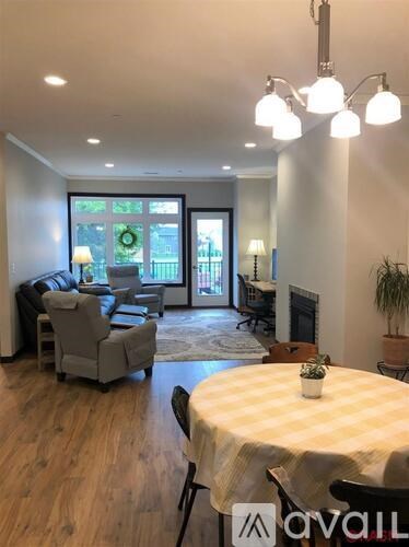 A living room with a dining table set up with a plant on it.