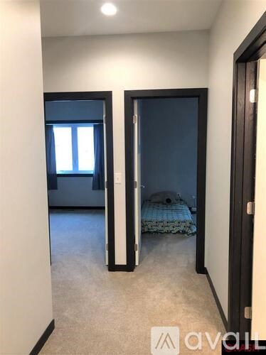 A bedroom with a bed and a window.