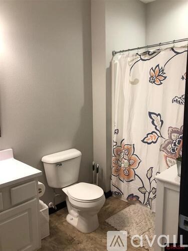 A white toilet sits next to a white sink in a bathroom.