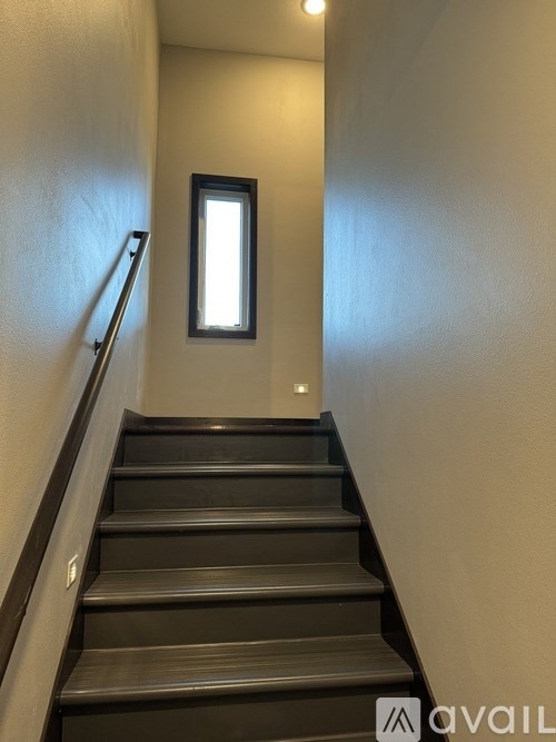 A staircase with a window above it.