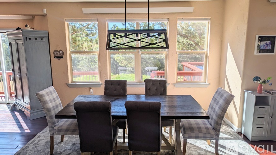 A dining room with a table and chairs.