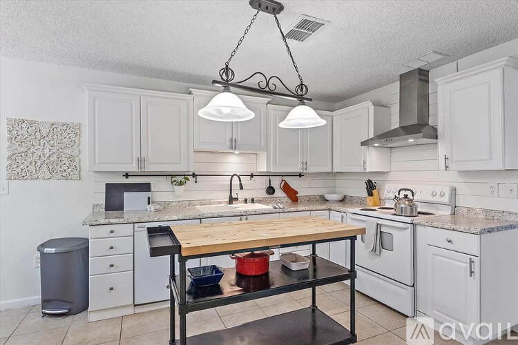 A kitchen with a table and chairs in the middle of it.