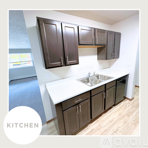 A kitchen with brown cabinets and a white countertop.
