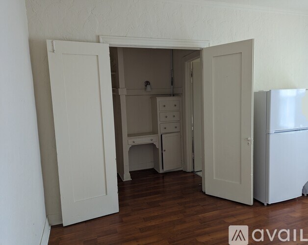 A kitchen area with a refrigerator and a sink.