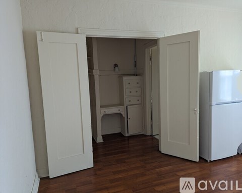 A kitchen area with a refrigerator and a sink.
