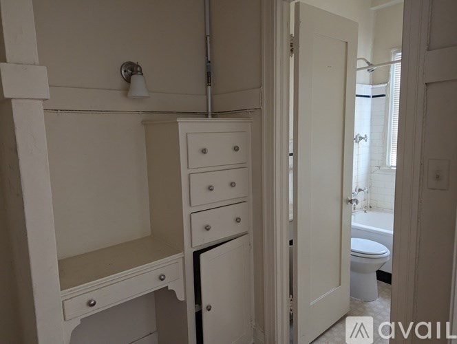 A white bathroom with a toilet, sink, and bathtub.