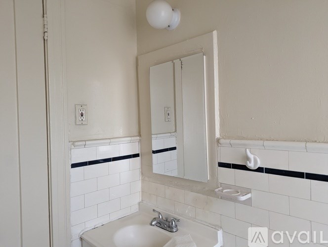 A bathroom with a sink and mirror.