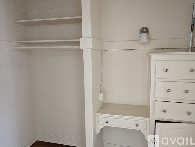 A white closet with a shelf and drawers.