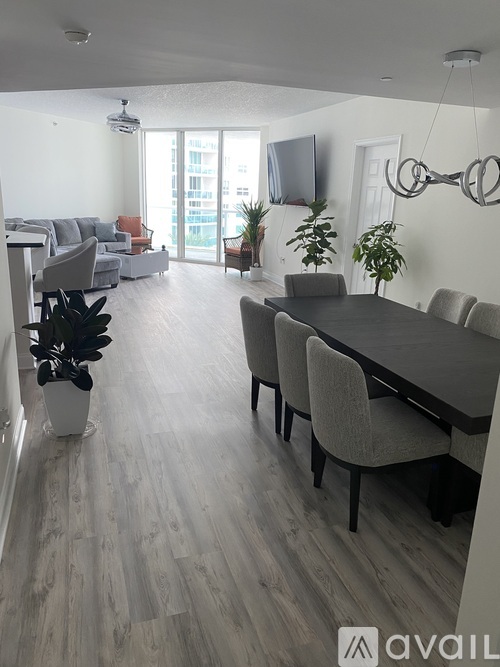 A modern dining room with a large table and chairs.