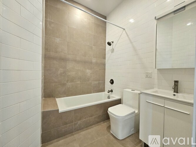 A bathroom with a white toilet, a bathtub, and a sink.