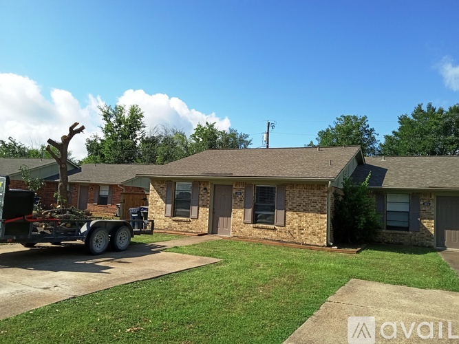 A house with a carport and a truck parked in front.