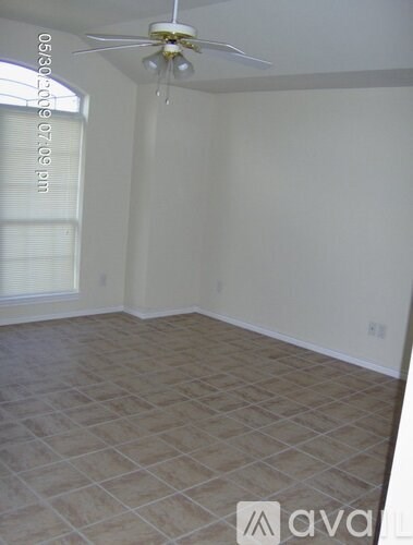 A room with a tiled floor and a ceiling fan.