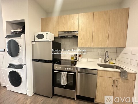 A kitchen with wooden cabinets and stainless steel appliances is for sale.
