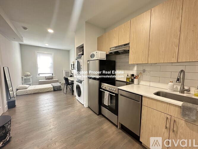 A kitchen with a washer and dryer built in.