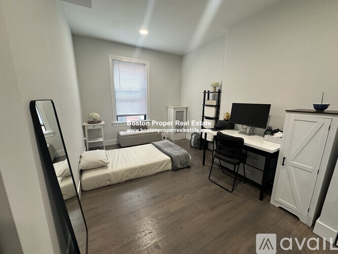 A bedroom with a bed, desk, and chair is available for rent.